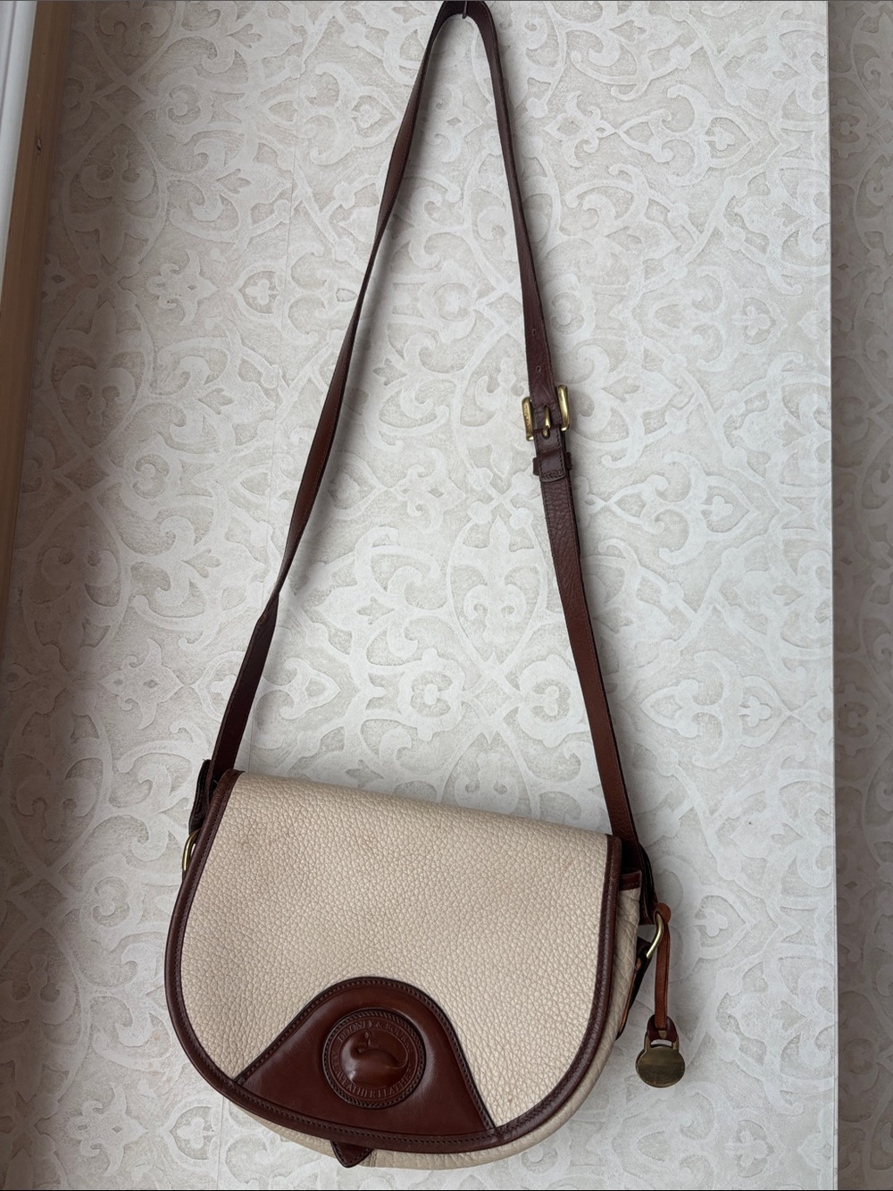 Dooney & Bourke Cream and Brown Pebbled Leather Crossbody Saddle Bag - Picture 2 of 6